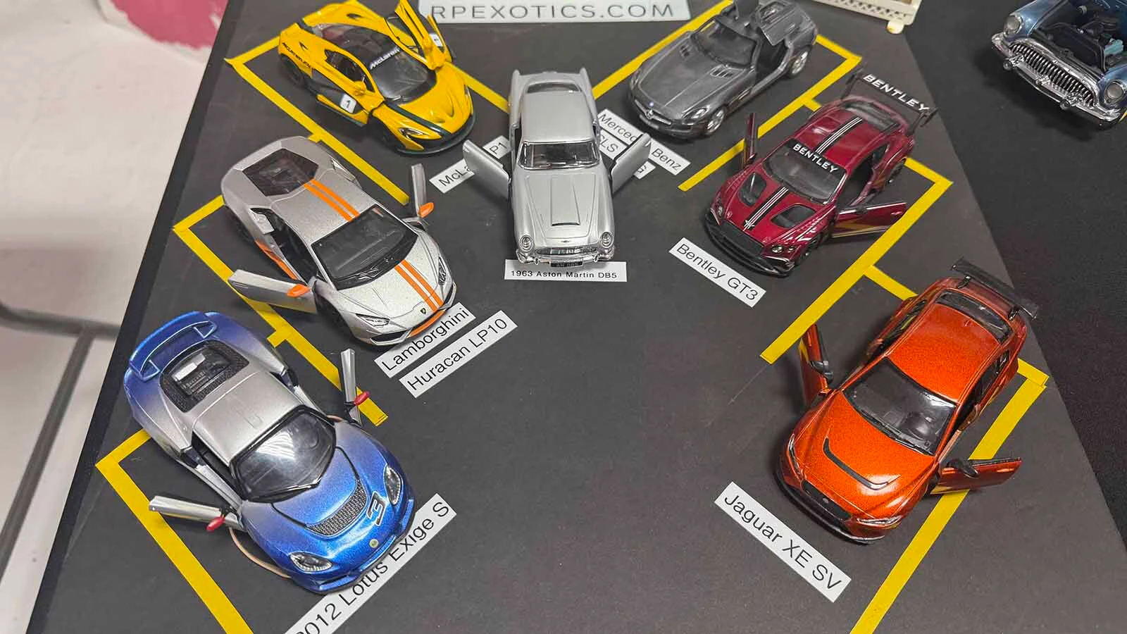 Ed Downes was inspired to create a miniature exotic car display after going to the real thing with his grandson. The only difference is that he added the Aston Martin DV5, a James Bond car, to his display.