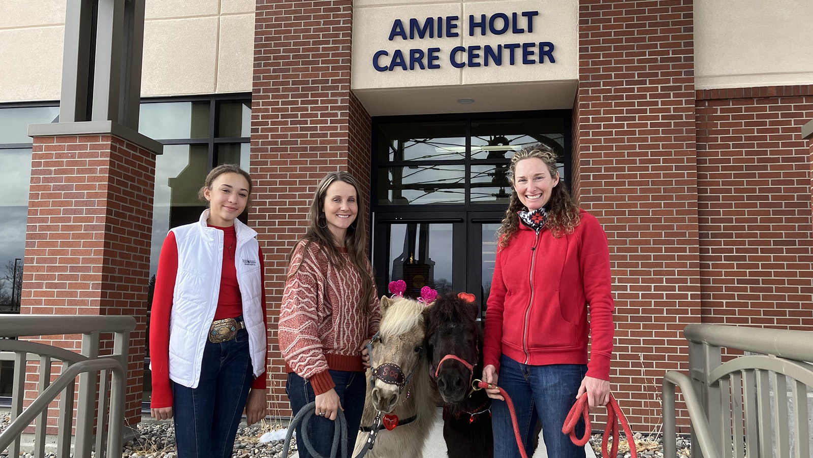Bringing Valentine’s Day happiness to residents of the Amie Holt Care Center in Buffalo on Monday was the goal of Kamryn Carden, left, Nicole Henry, Tootsie Roll, Chip and Candice Carden.