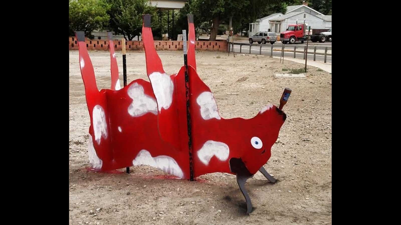 The first cow that was purchased by Joe’s Liquor and Bar was spray painted and put upside down with a beer bottle in its mouth.