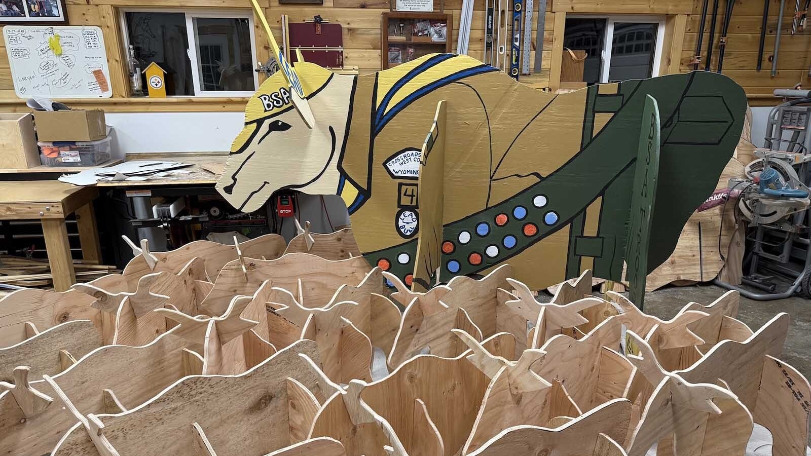 The full-size cow that Boy Scouts of America Troop 4 displays towers above the “mini-cows” made to sell to local residents.