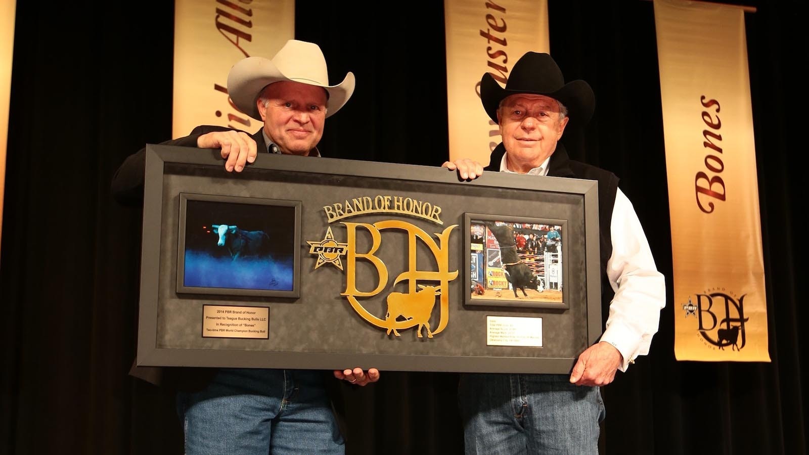 Tom Teague, right, receives the Brand of Honor for Bones, a virtually unridable rodeo bull.