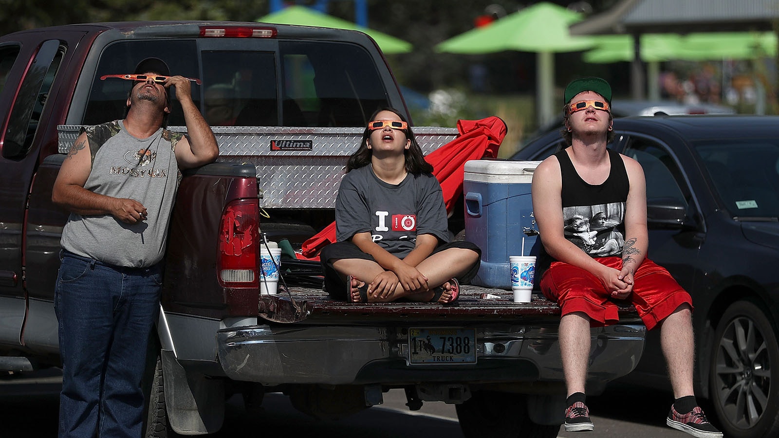 Visitors look at the solar eclipse at South Mike Sedar Park on Aug. 21, 2017, in Casper, Wyoming.