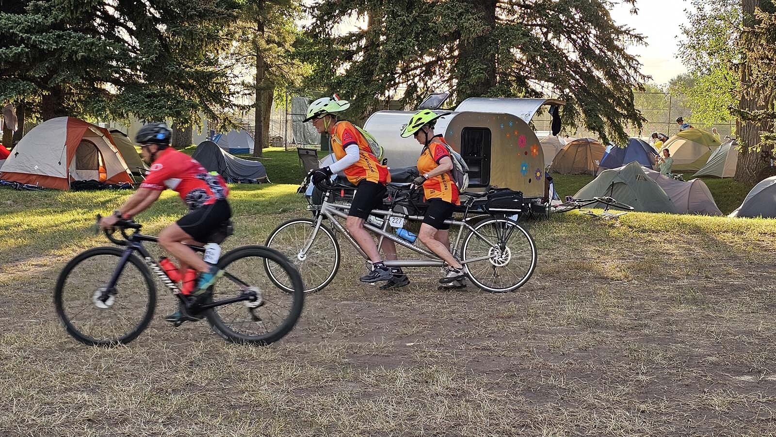 Riders taking off for Sinks Canyon, a couple of them with cowboy hat bike helmets they purchased online.