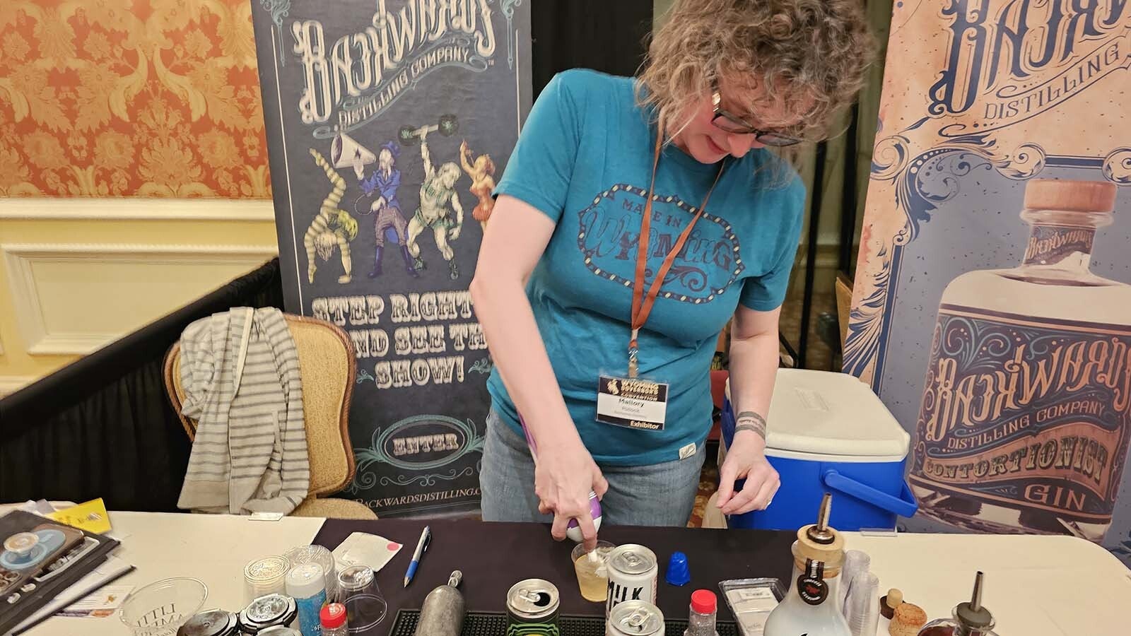Mallory Pollack mixes up an "Ice Palace," this year's Backwoods Distilling cocktail for the 2024 Wyoming Governor's Hospitality and Tourism Convention.