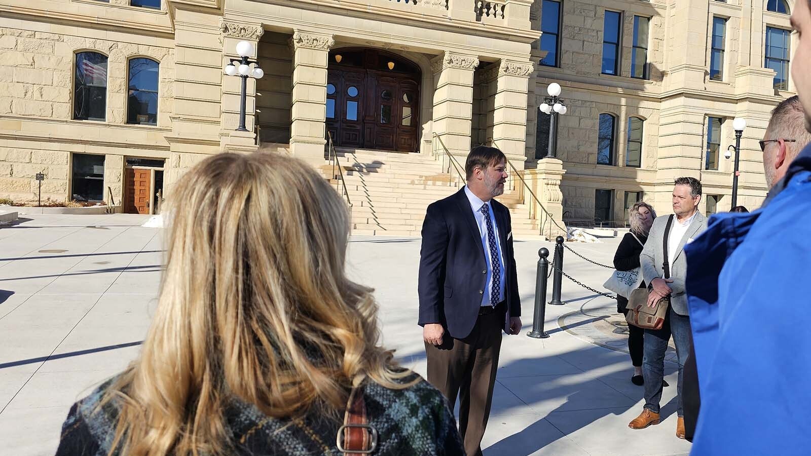 Wyoming Hospitality and Travel Coalition Executive Director Chris Brown marshals the troops in front of the capital for a showing of the Wyoming Hospitality and Travel Coalition during the Wyoming Governor's Hospitality & Tourism Convention on Monday in Cheyenne.