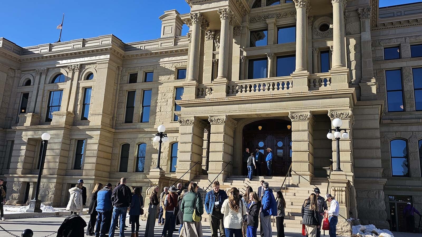 Members of the Wyoming Hospitality and Travel Coalition gather in front of the Capitol after visiting both the Senate and the House on Monday.