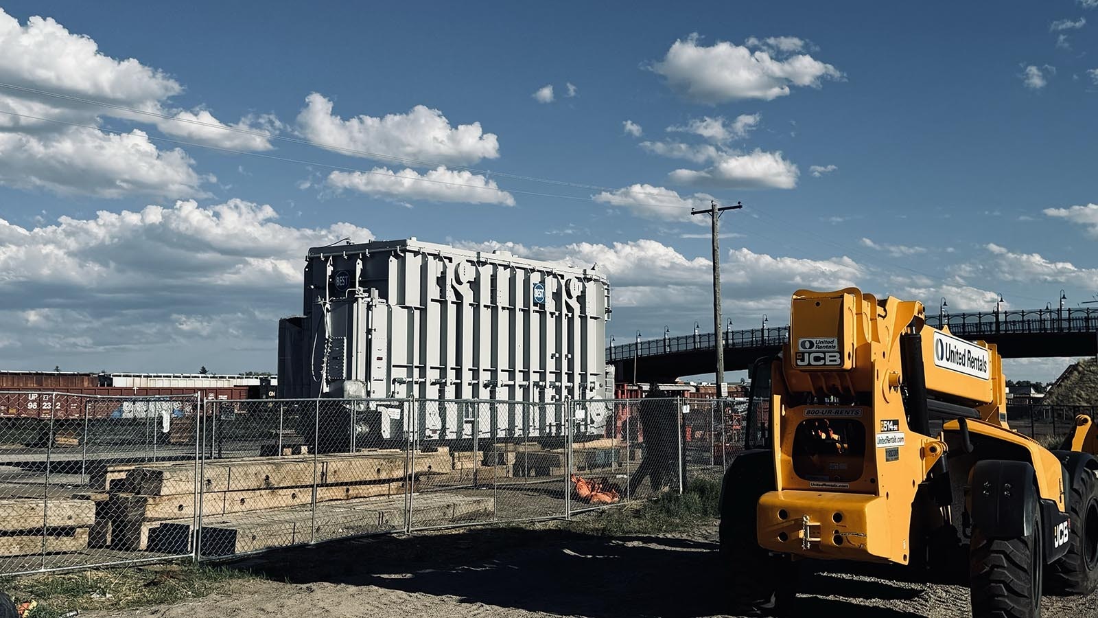 A transformer built in Turkey was sent via container ship to the Port of Houston, then shipped by rail to Laramie, Wyoming, for eventual installation at PacifiCorp’s Aeolus substation north of Medicine Bow, Wyoming. Above, the transformer sits in the rail yards of Laramie, waiting to be moved 90 miles to the north.