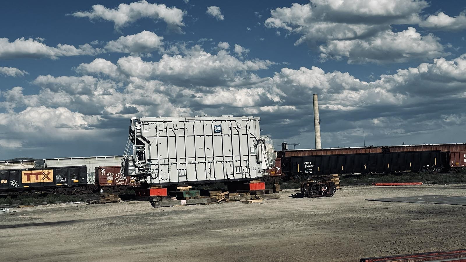 A transformer built in Turkey was sent via container ship to the Port of Houston, then shipped by rail to Laramie, Wyoming, for eventual installation at PacifiCorp’s Aeolus substation north of Medicine Bow, Wyoming. Above, the transformer sits in the rail yards of Laramie, waiting to be moved 90 miles to the north.