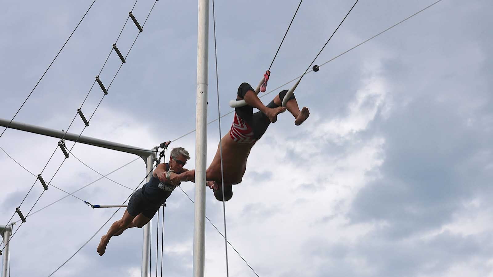 Steve Tobi catches his wife, Patty, after she launched from the trapeze bar.