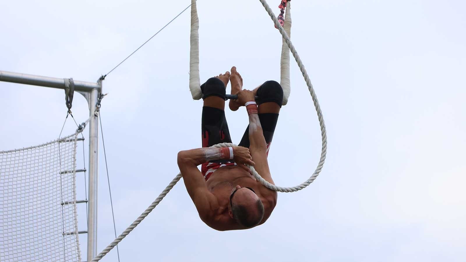 Steve Tobi finishes his climb up to the catcher’s trapeze off a rope in preparation for a practice session.