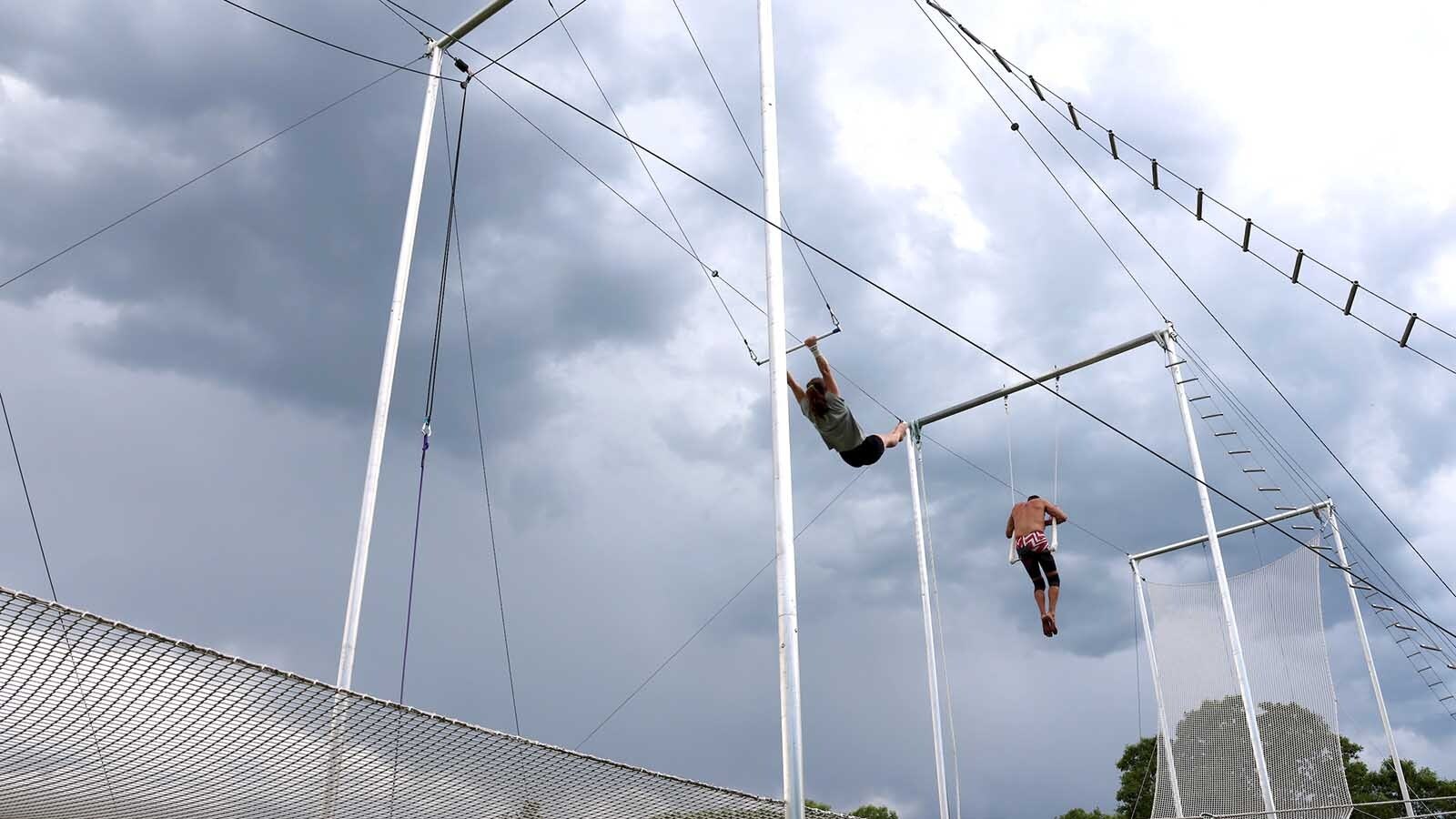 Amy Walters swings out over the net to practice and warm up. Trapeze is hard on the shoulders.
