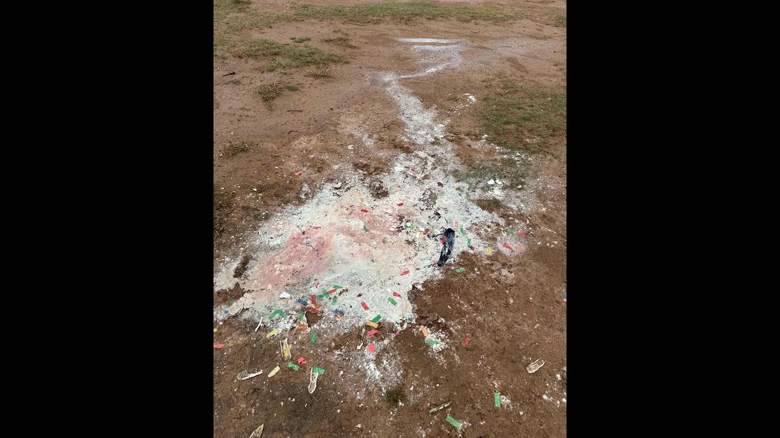 Colorful debris and other trash is scattered across the dirt at the illegal dumping site on public land near Evanston.