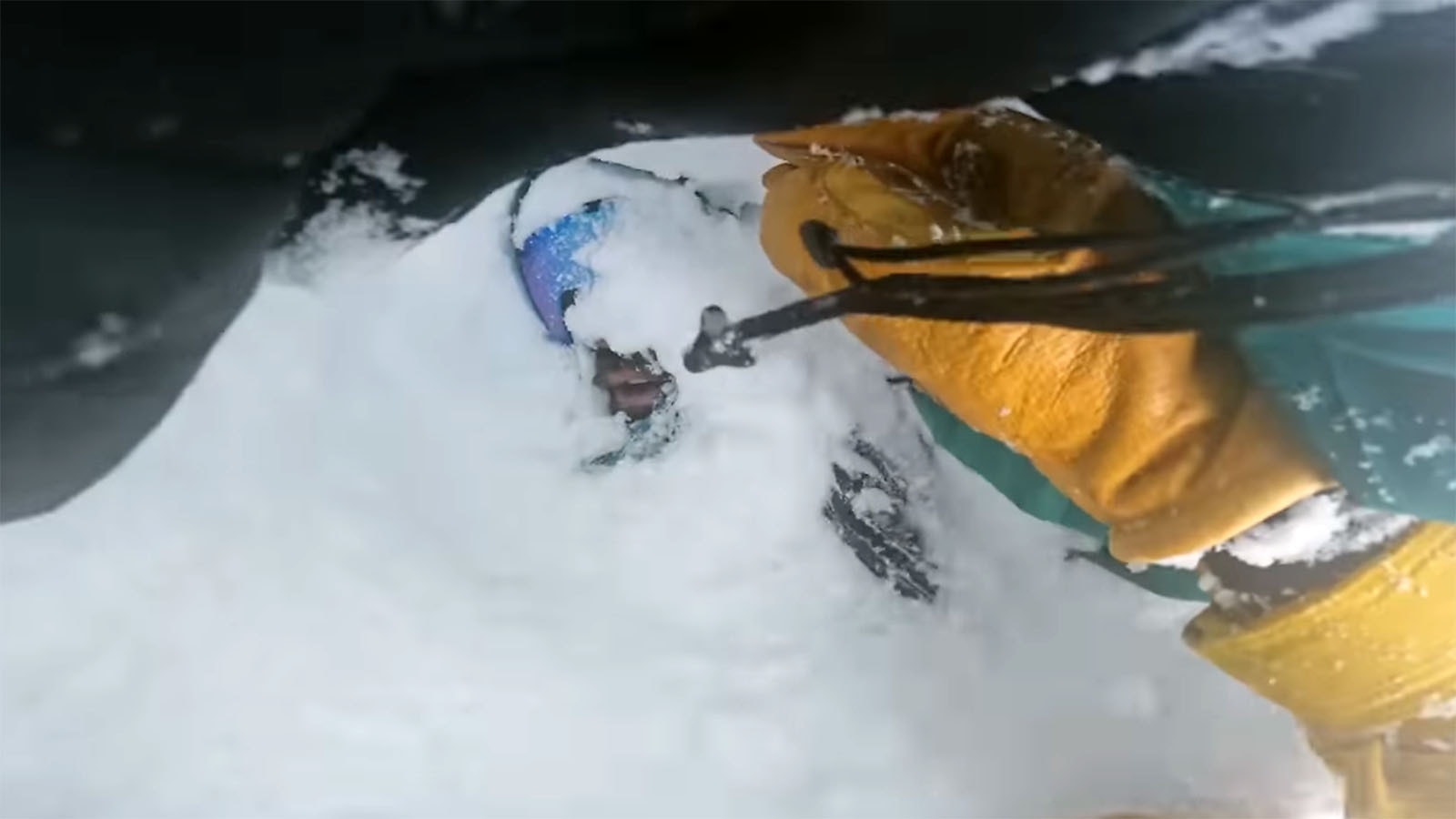 An image from Francis Zuber's GoPro camera shows the moment he uncovered the mouth and face of a snowboarder who'd tumbled head-first into a deep tree well. The snowboarder, Ian Seeger, was fine thanks to Zuber digging him out.