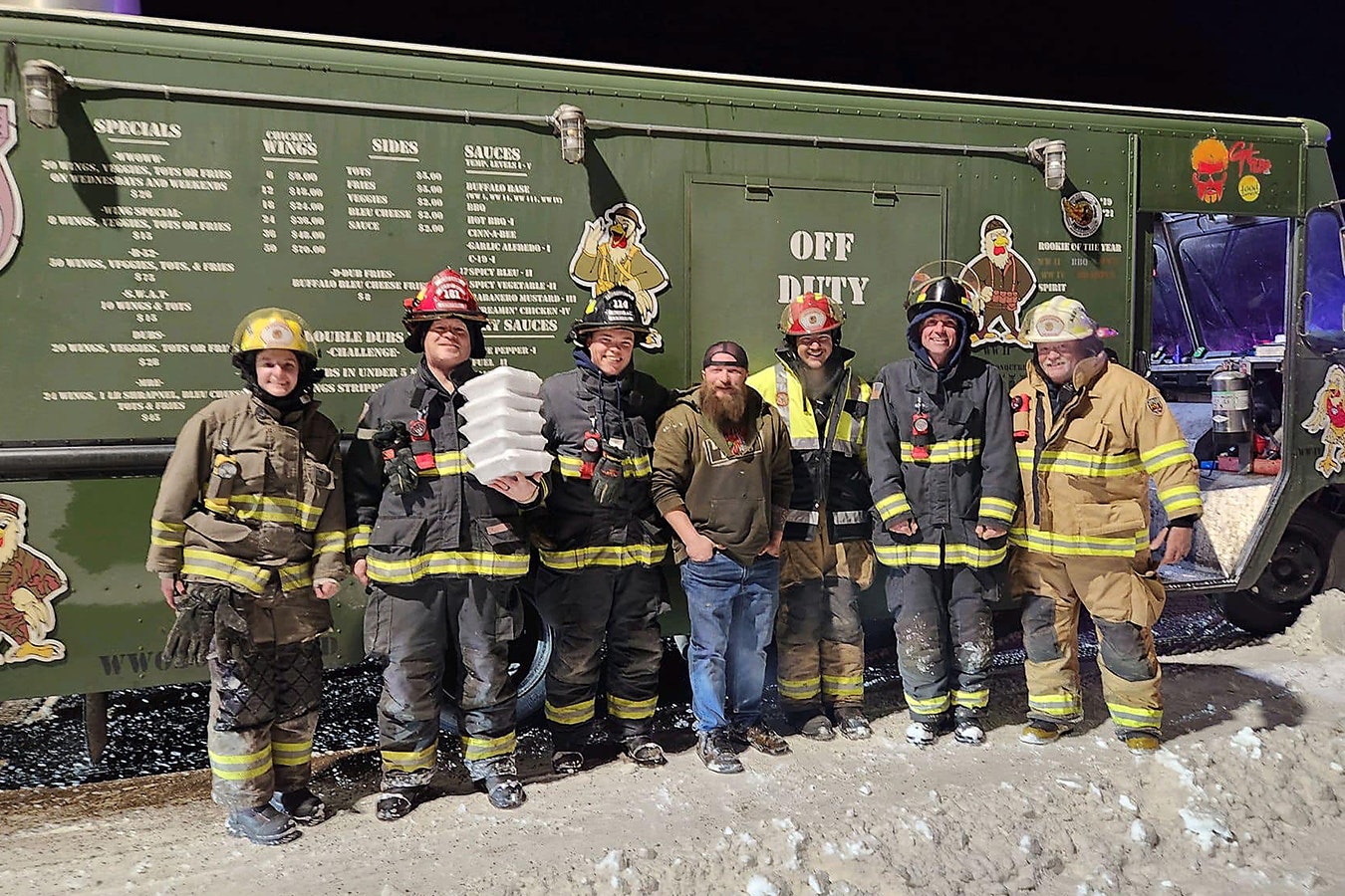 Weizens Wings owner Trend Weitzel, center, with members of the Vedauwoo Volunteer Fire Department on Sunday after stopping at the scene of a car fire Sunday to feed the crews at the scene.