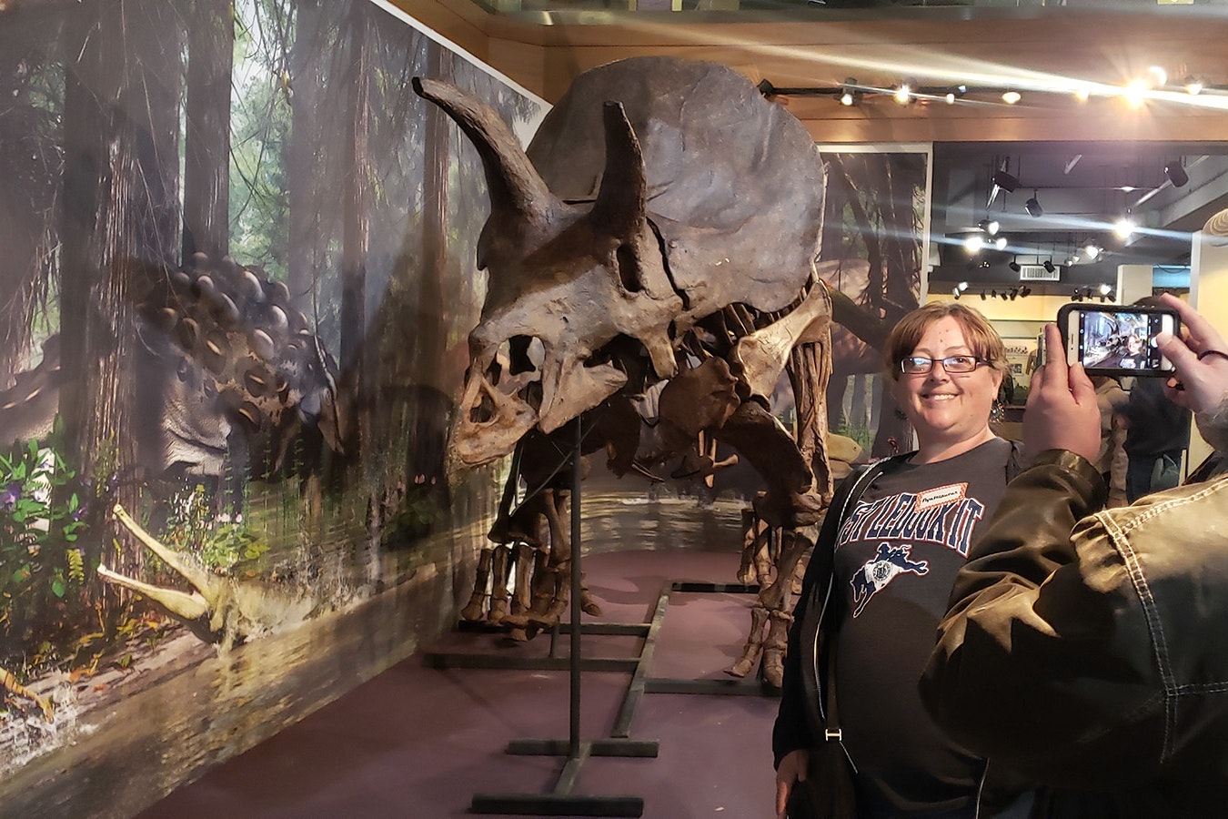 Shelly Araas poses for a selfie with a Triceratops for her classroom taken by her husband Ryan during a recent Jurassic party for the new exhibit at the Wyoming State Museum in Cheyenne.