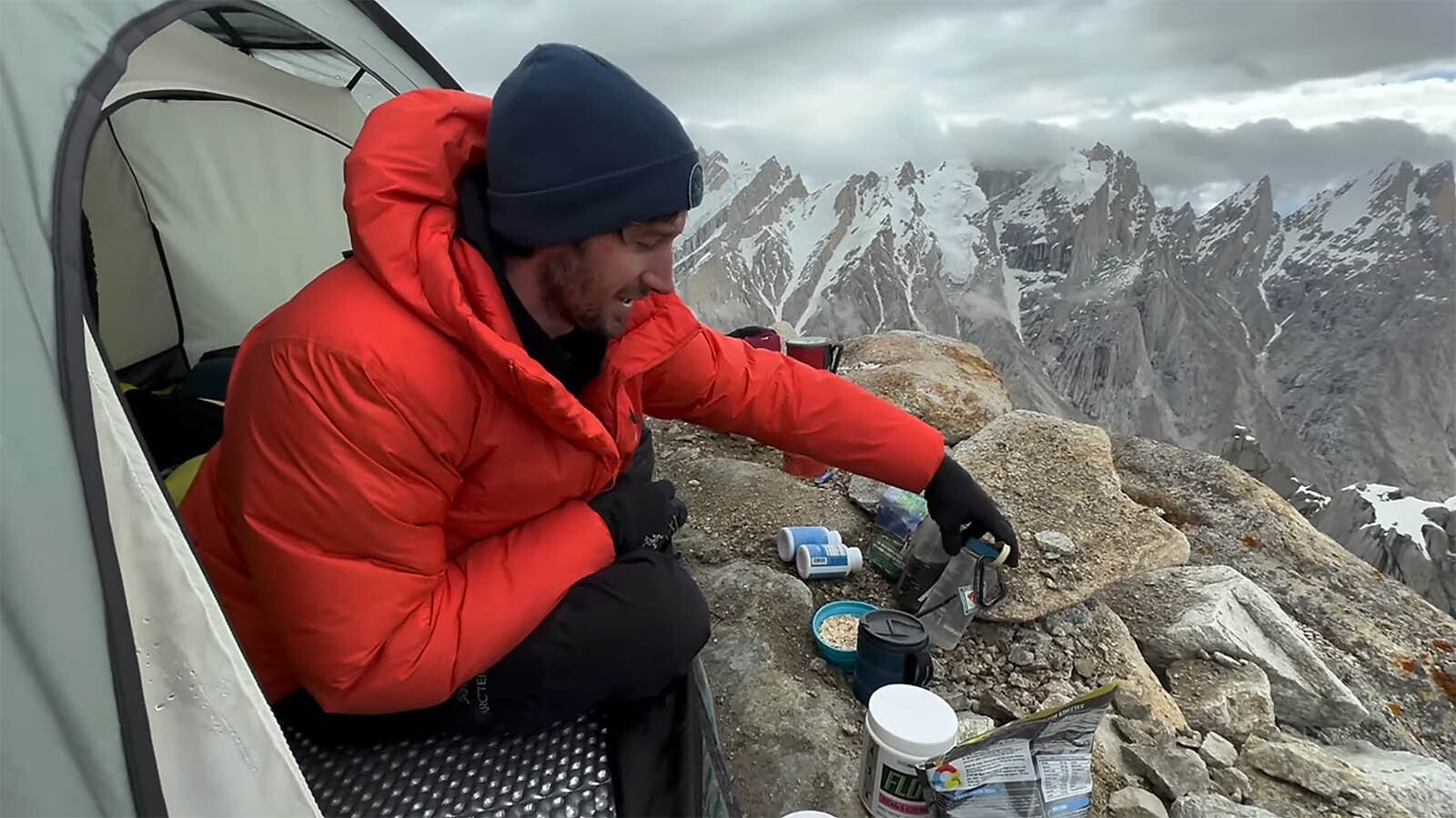 Jordon Cannon fuels up with breakfast high up on the narrow side of Trango Towers.