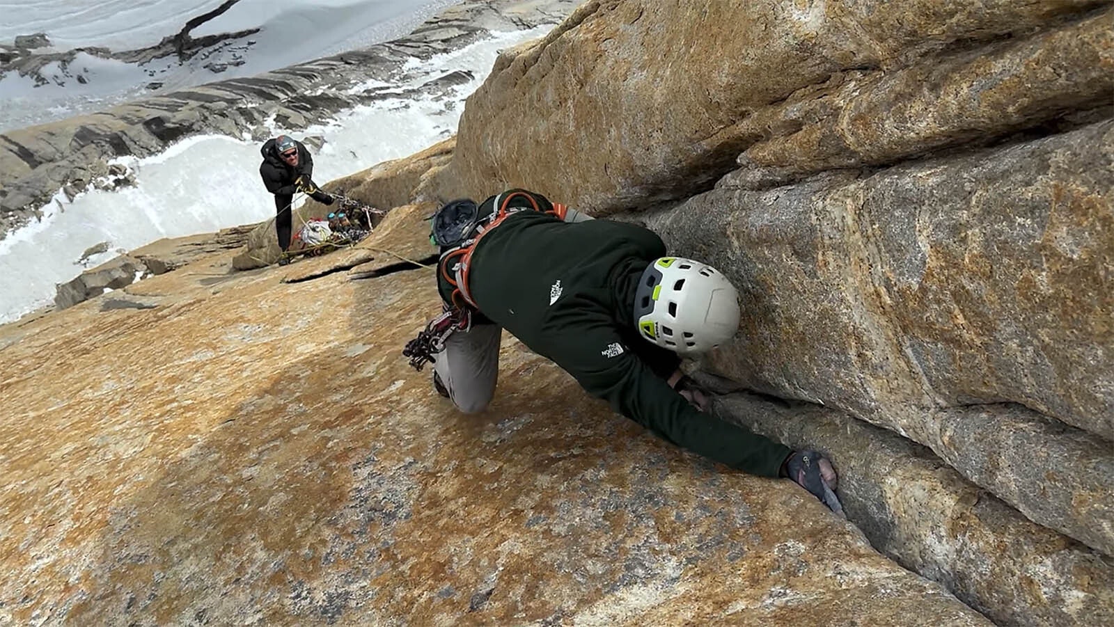 Finding handholds in the narrow cracks of vertical rock.