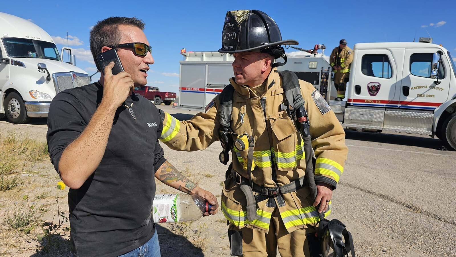 A firefighter checks on Nathan Frederick while he's on the phone calling his girlfriend for a ride.