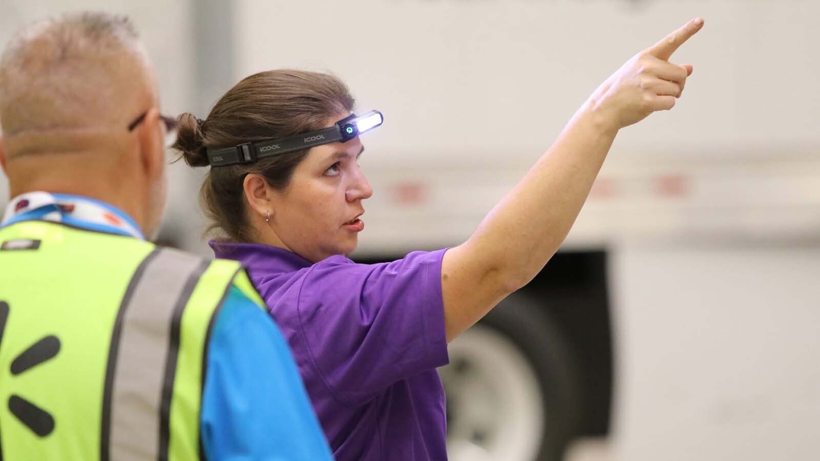 Jessica Smith of Shoshoni, Wyoming, competed in the National Truck Driving and Step Van Driving Championships this past weekend. Part of the competition was a pretrial competition, where contestants must find all the defects on their truck before they begin their drive. Smith is pointing out a defect on the front of the truck within her allowed six minutes.