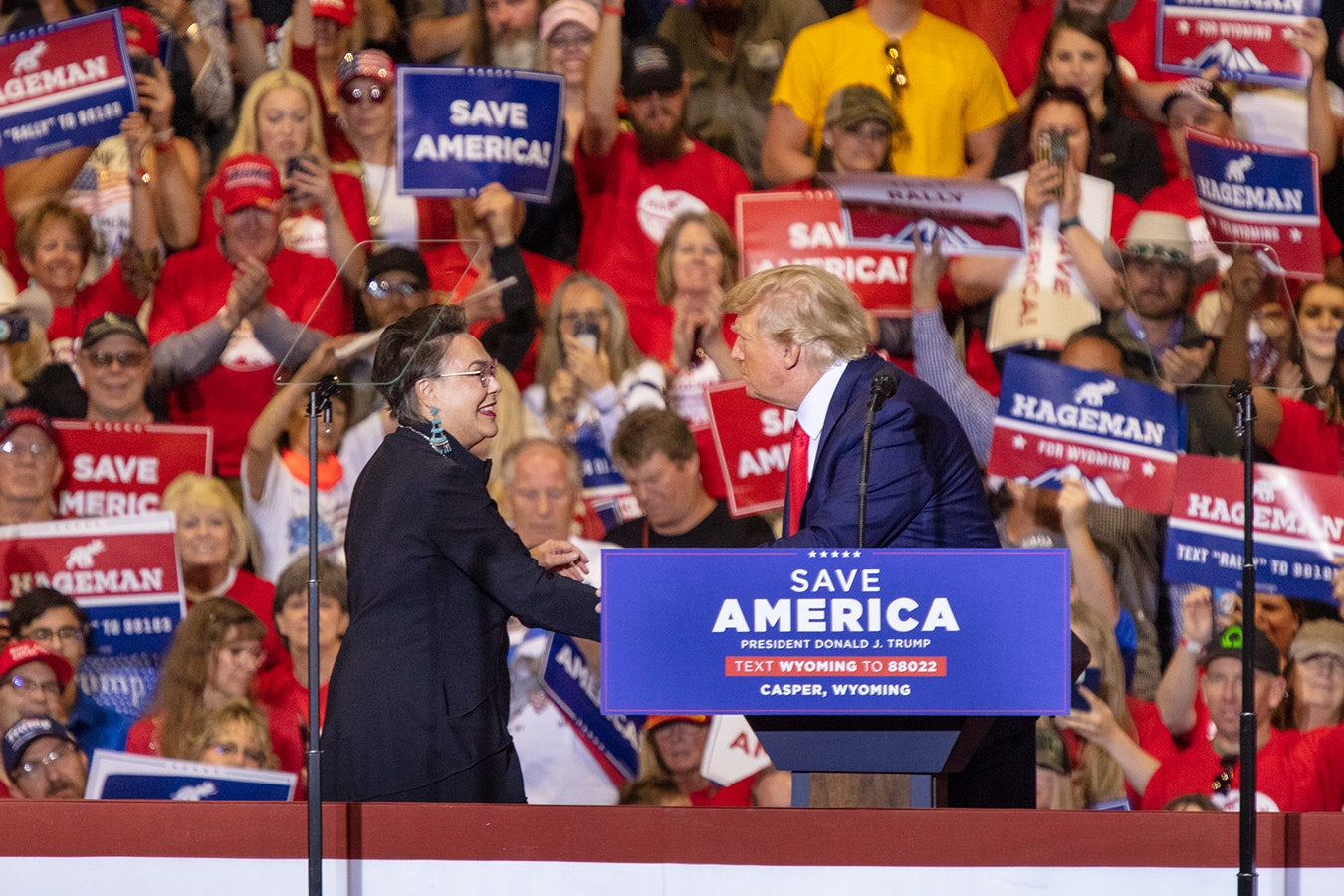 Harriet Hageman, left, shakes hands with former President Donald Trump at a Save America rally in Casper, Wyoming, in May 2022.