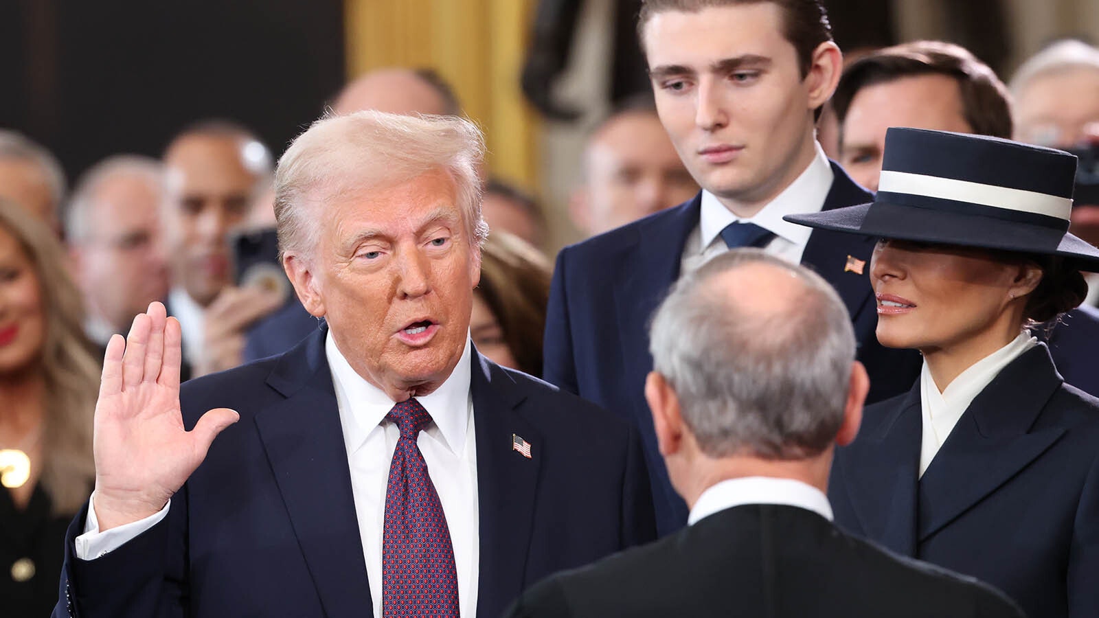 Donald Trump is sworn into office by Supreme Court Chief Justice John Roberts as Melania Trump holds the Bible in the U.S. Capitol Rotunda on Jan. 20, 2025, in Washington, D.C. Donald Trump takes office for his second term as the 47th president of the United States.