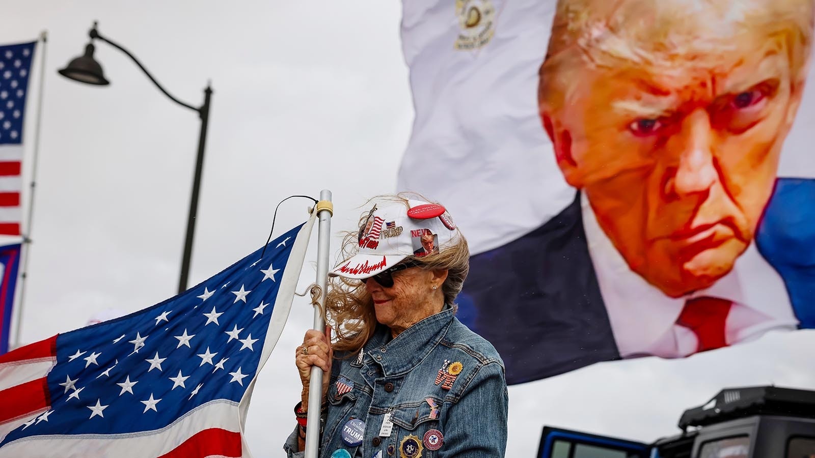 Mary Kelley supports U.S. President-elect Donald Trump near his Mar-a-Lago resort on Dec. 14, 2024. President-elect Trump has threatened to impose new tariffs when he takes office next month.