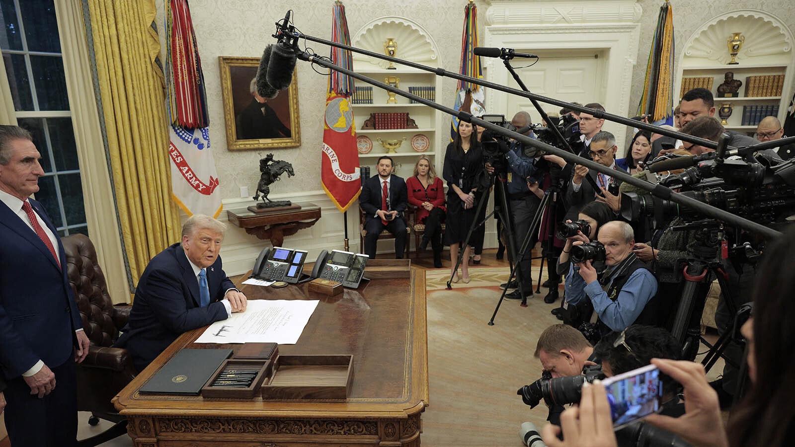 President Donald Trump talks with the press about imposing tariffs on China, Canada and Mexico "starting tomorrow" while in the Oval Office on Friday, Jan. 31, 2025.