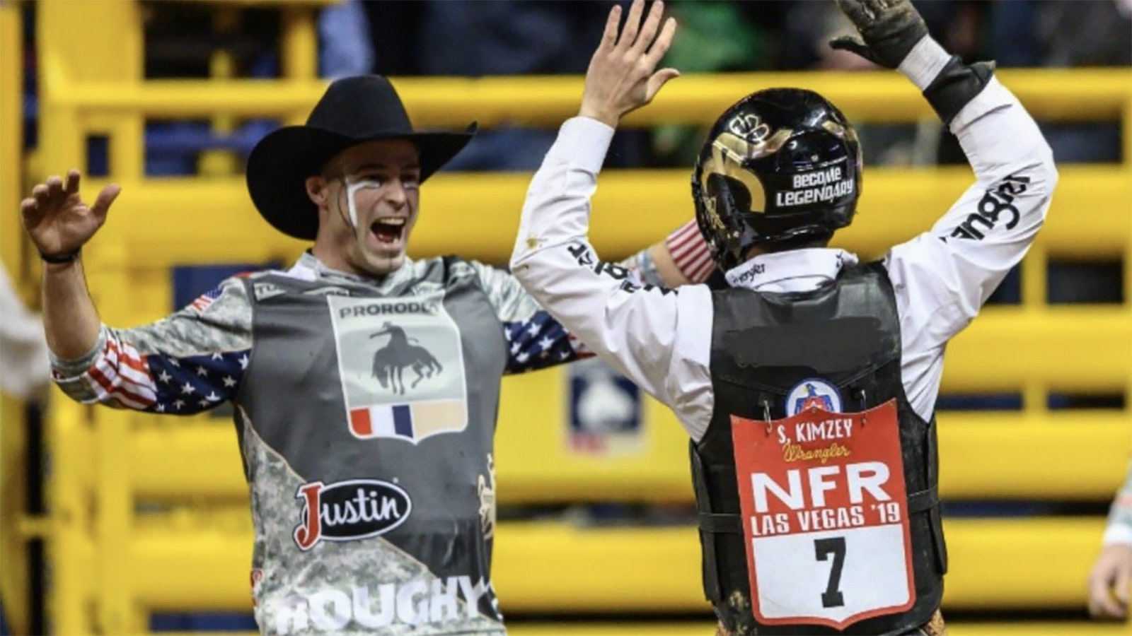 Bullfighter Dusty Tuckness, left, and bull rider Sage Kimzey celebrate a successful ride at the 2019 National Finals Rodeo.