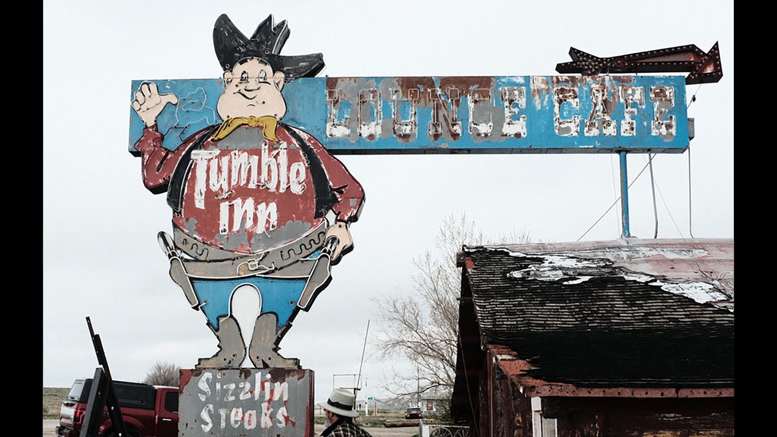 The Tumble Inn sign before its hat and top of the cowboy's head was removed to begin restoration. When they saw the top off of it, some people speculated wind had blown the top off.