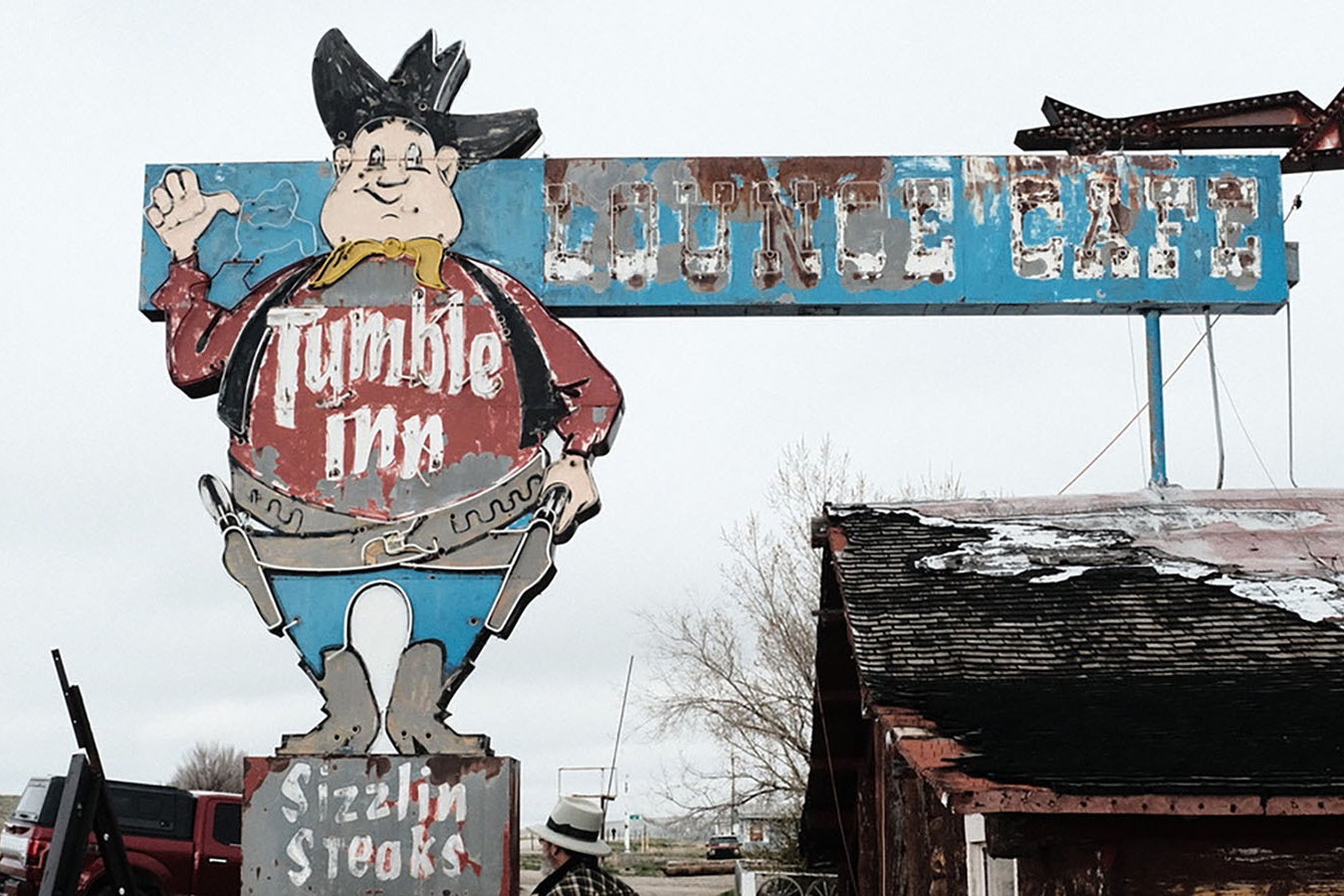 The Tumble Inn sign before its hat and top of the cowboy's head was removed to begin restoration. When they saw the top off of it, some people speculated wind had blown the top off.