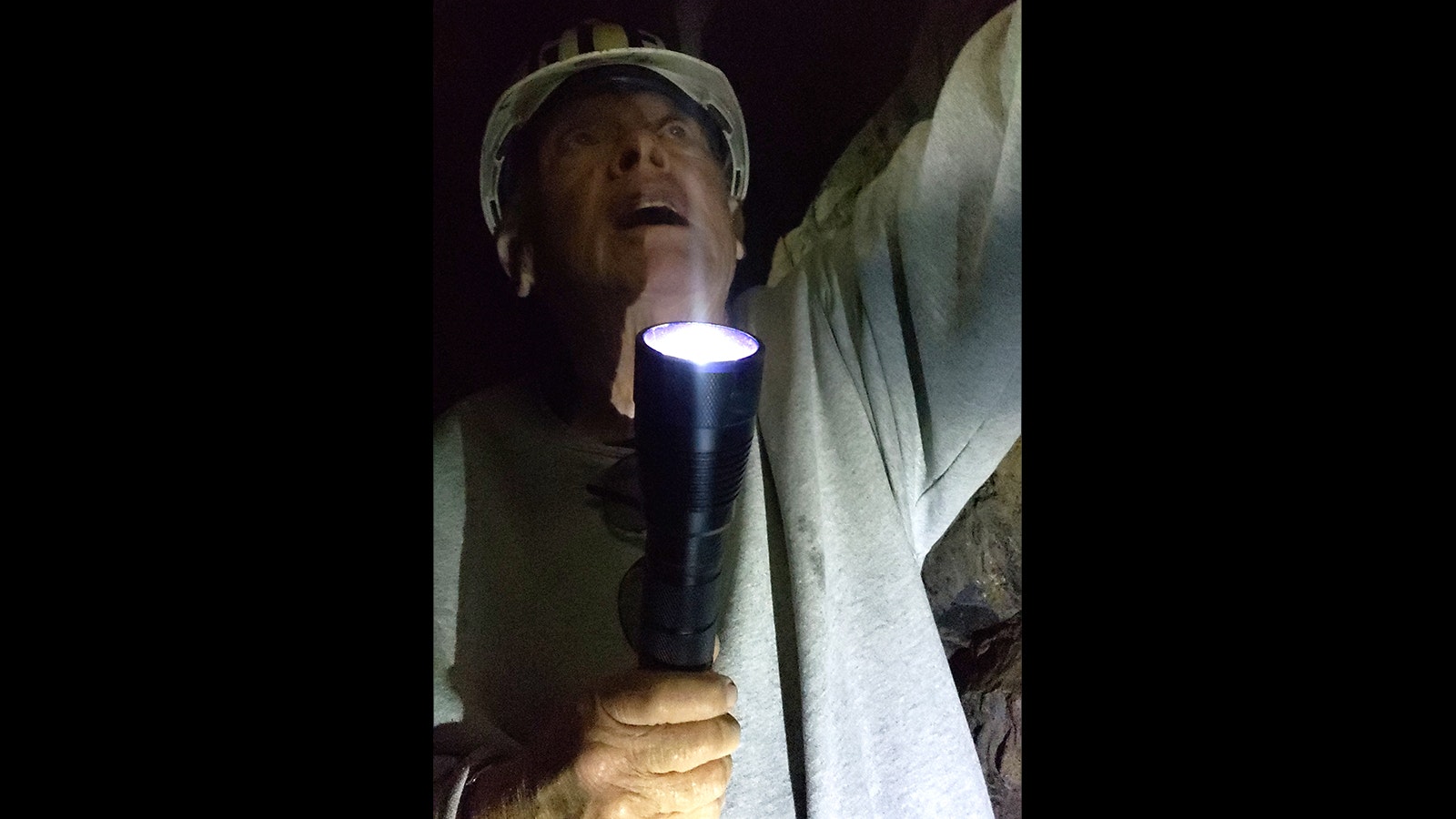 Glen Hester shines a flashlight on a wooden plug driven into the ceiling of the English Tunnel.