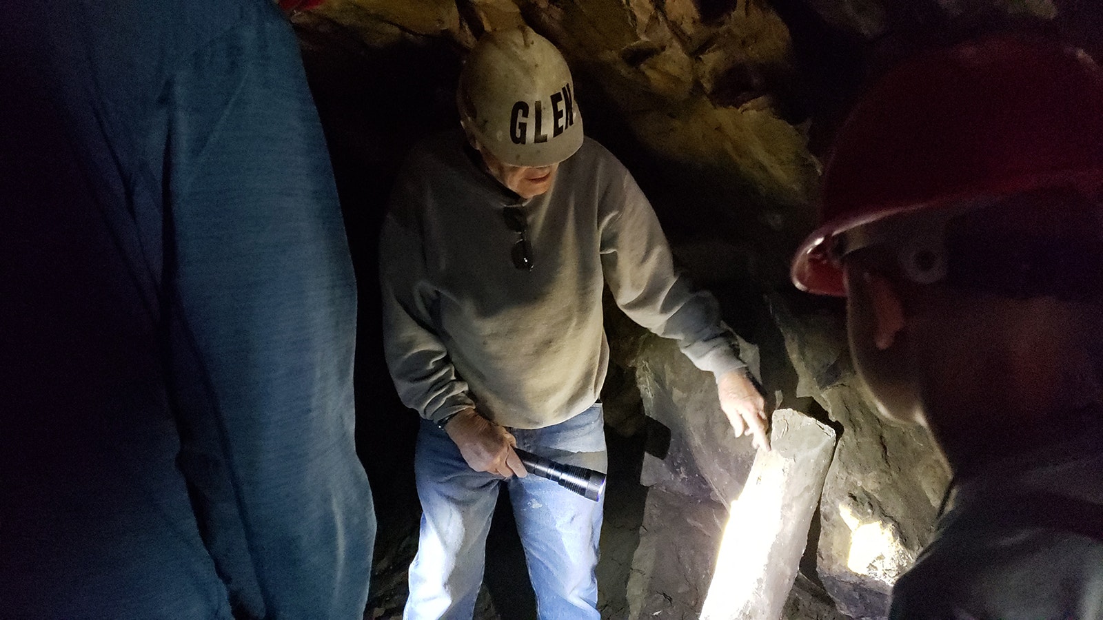 Glen Hester shines a flashlight on square nails in a large post left inside the English Tunnel. The tunnel was a low oxygen environment, which helped preserve the artifacts in it.