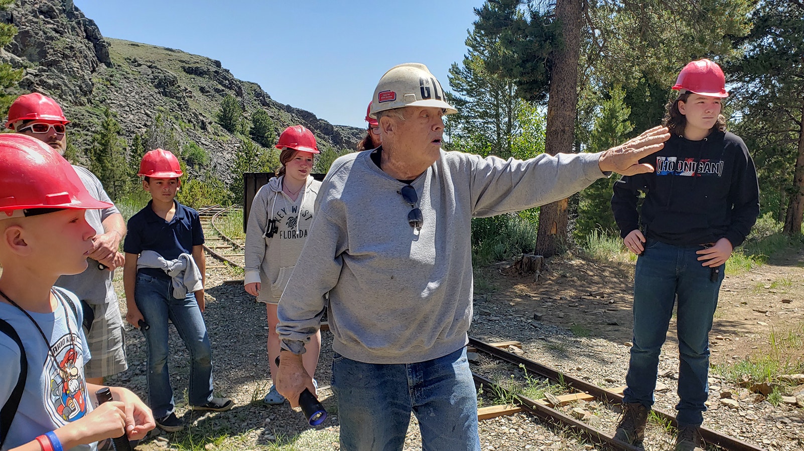 Glen Hester tells a tour group the story of how the English Tunnel was discovered at South Pass City just before heading into the tunnel itself.