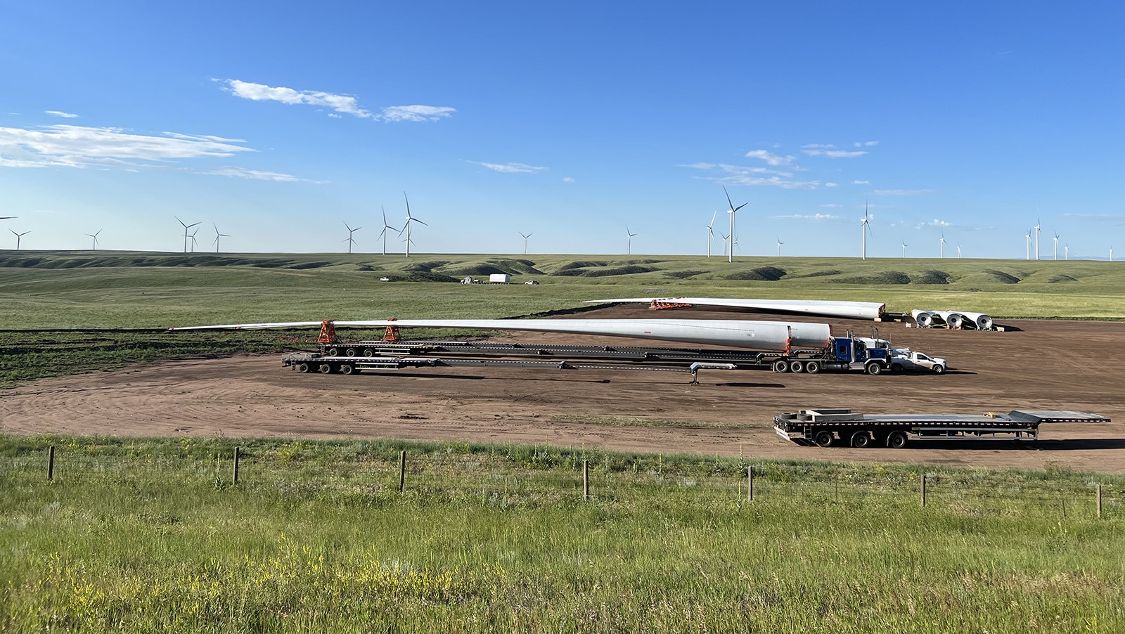 With a wind farm in the background, a staging area for new turbines is sited along Interstate 80 between Cheyenne and Laramie this summer.