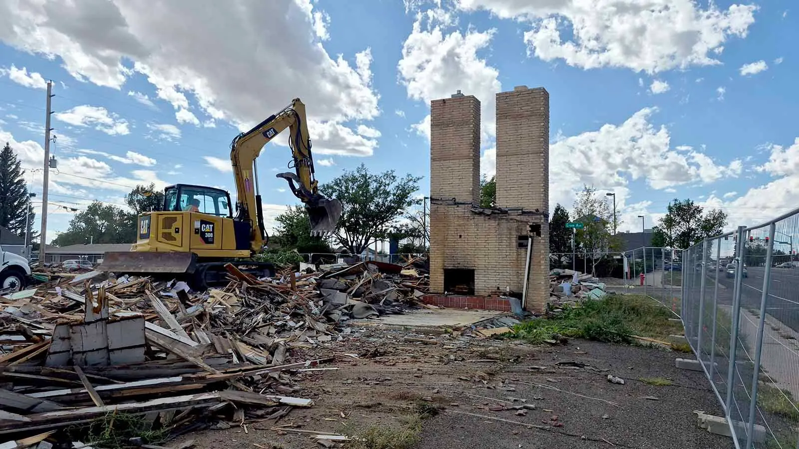 Chuck Harter of the McCarty & Sons construction firm in Denver finishes knocking down the twin chimneys at the historic Twin Chimneys Motor Court built in the 1950s in Cheyenne on Tuesday. A 7 Brew Coffee stand will be built on the site.