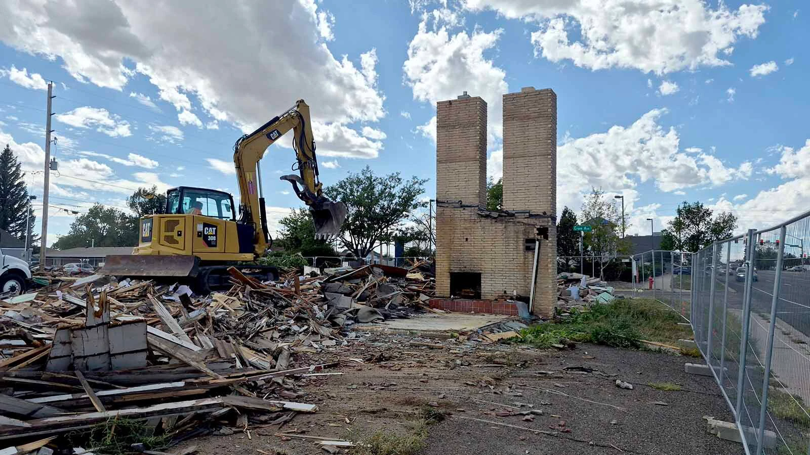 Chuck Harter of the McCarty & Sons construction firm in Denver finishes knocking down the twin chimneys at the historic Twin Chimneys Motor Court built in the 1950s in Cheyenne on Tuesday. A 7 Brew Coffee stand will be built on the site.
