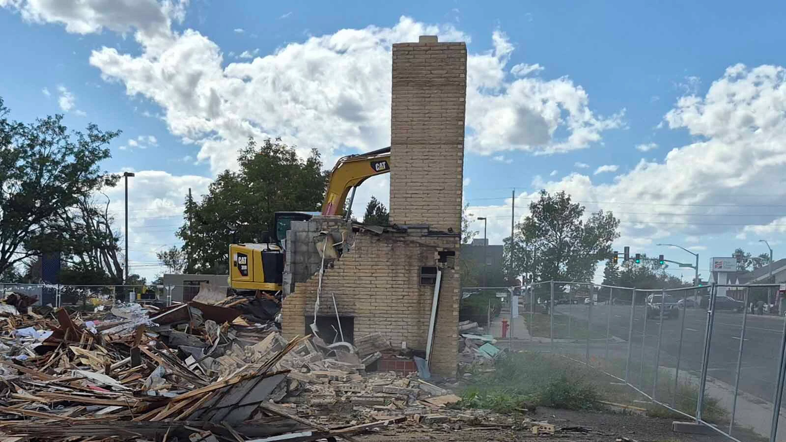 Chuck Harter of the McCarty & Sons construction firm in Denver finishes knocking down the twin chimneys at the historic Twin Chimneys Motor Court built in the 1950s in Cheyenne on Tuesday. A 7 Brew Coffee stand will be built on the site.