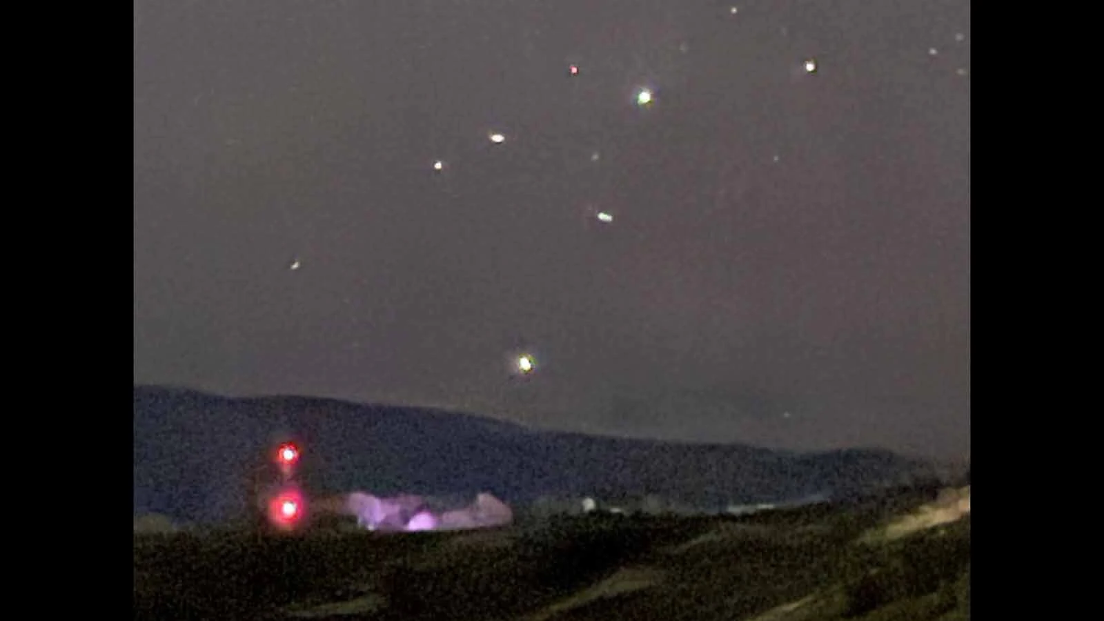 Mysterious lights rise in the night sky over Cedar Mountain near Cody, Wyoming.