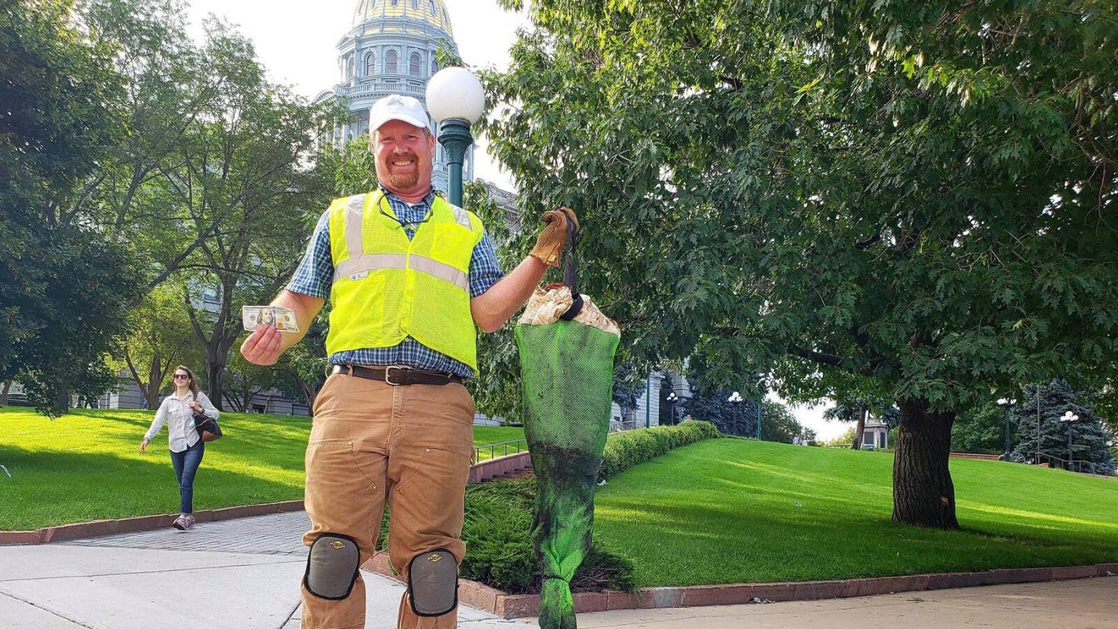 Brian Deurloo with Frog Creek Partners cleans out a gutter bin that was part of a pilot program in the Denver metro area that captured 1,300 pounds of trash in six months. This one also had a $100 bill.