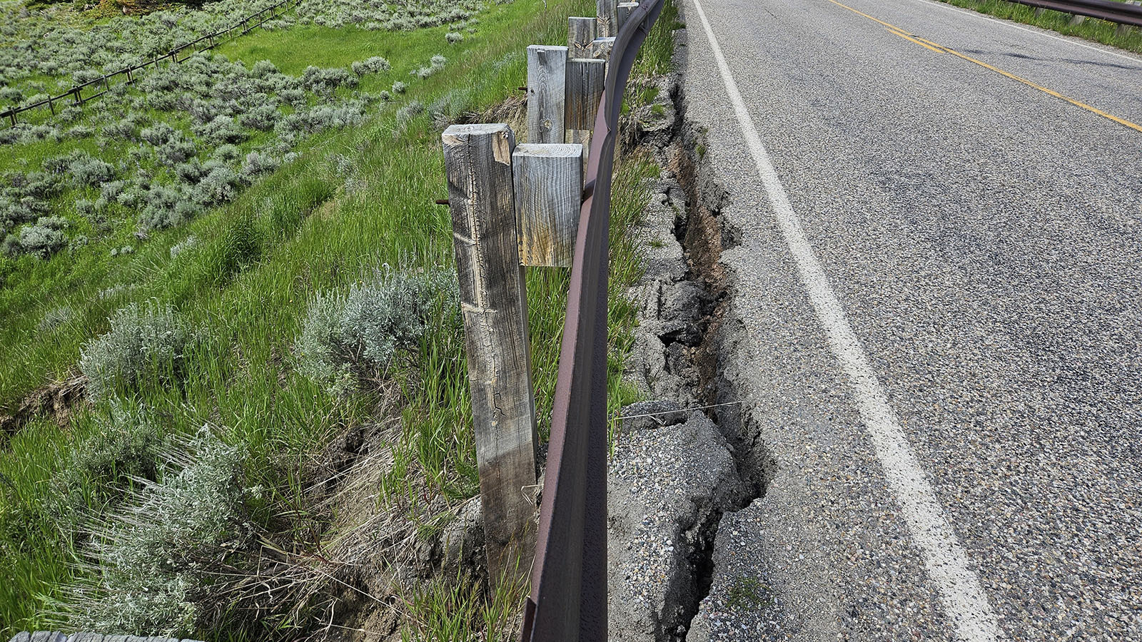 A mudslide along U.S. Highway 14 is separating the pavement from the shoulder of the road.