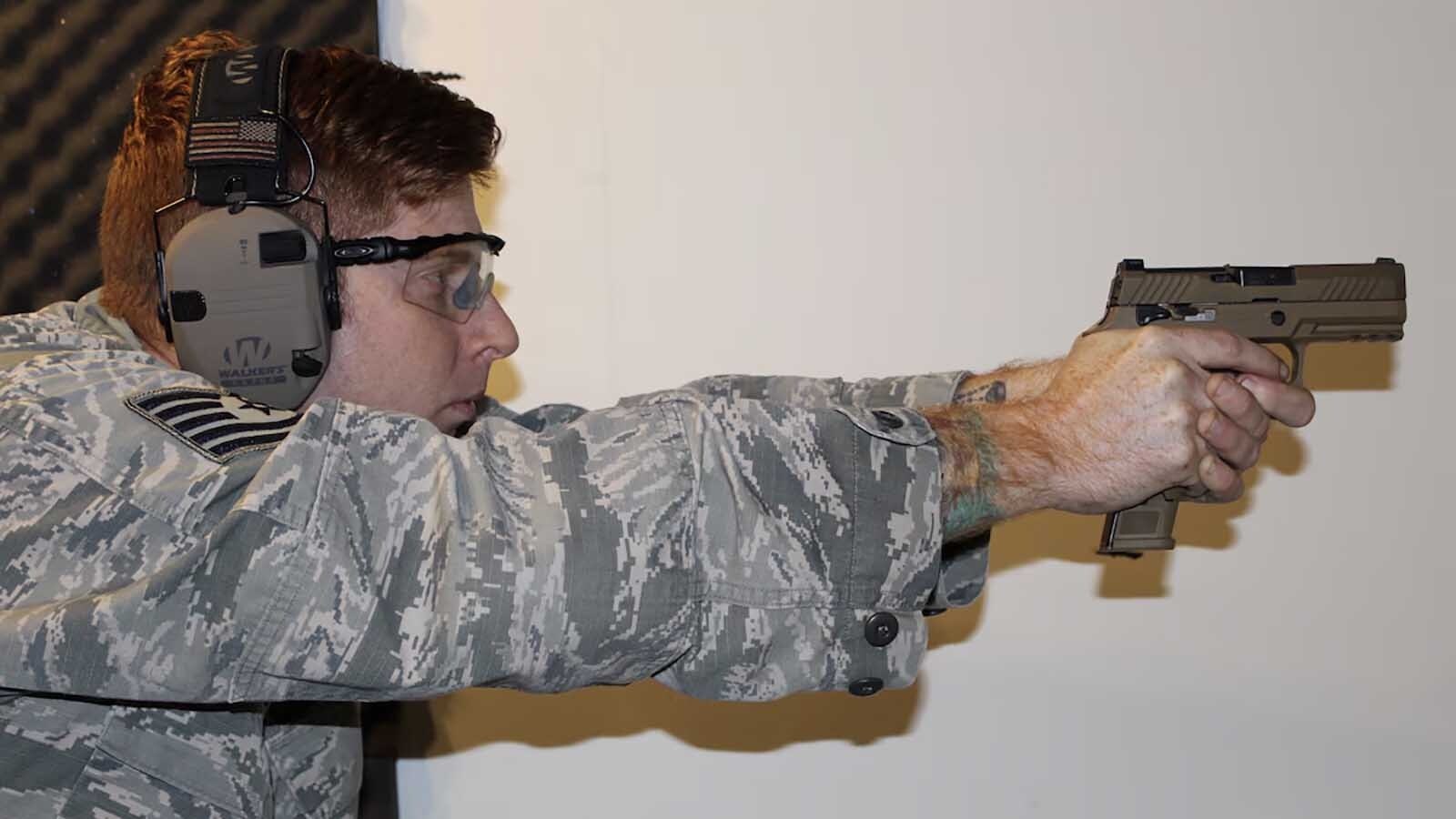 Tech. Sgt. Brady Craddock, Air Force Gunsmith Shop noncommissioned officer in charge, fires an M18 handgun in this file photo.