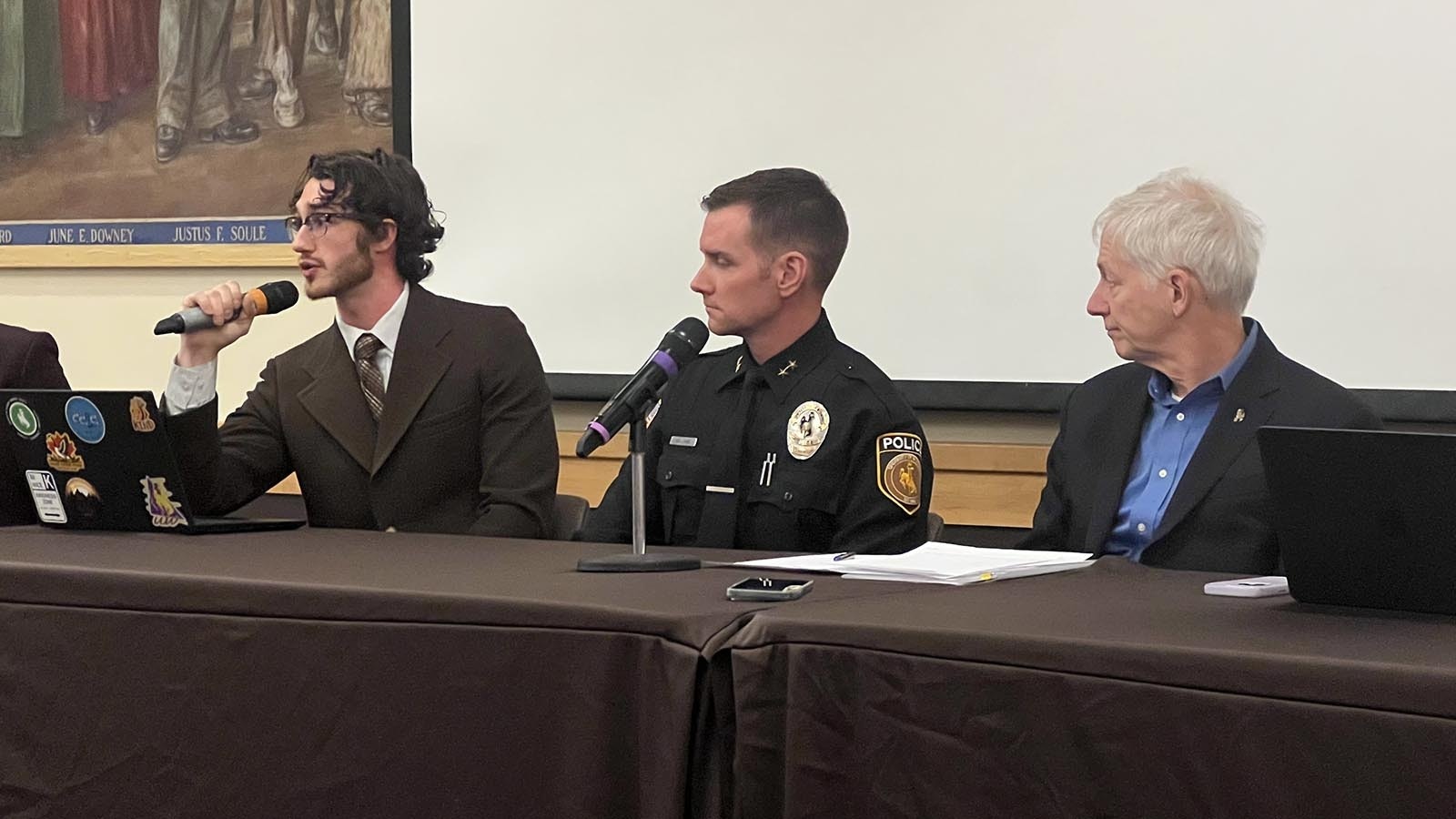 University of Wyoming Branding Iron Editor-in-Chief Ven Meester speaks during a town hall meeting Monday, regarding whether to allow people to carry concealed firearms at UW. Also pictured are UW Chief of Police Josh Holland and UW President Ed Seidel.