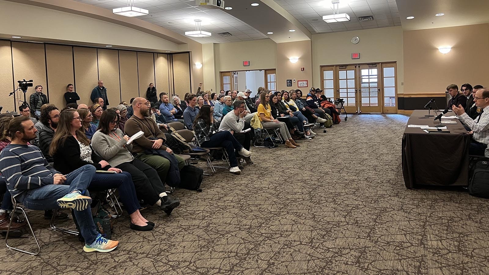 People listen to a panel discussion on Monday regarding whether to allow the carrying of concealed firearms on the University of Wyoming campus.