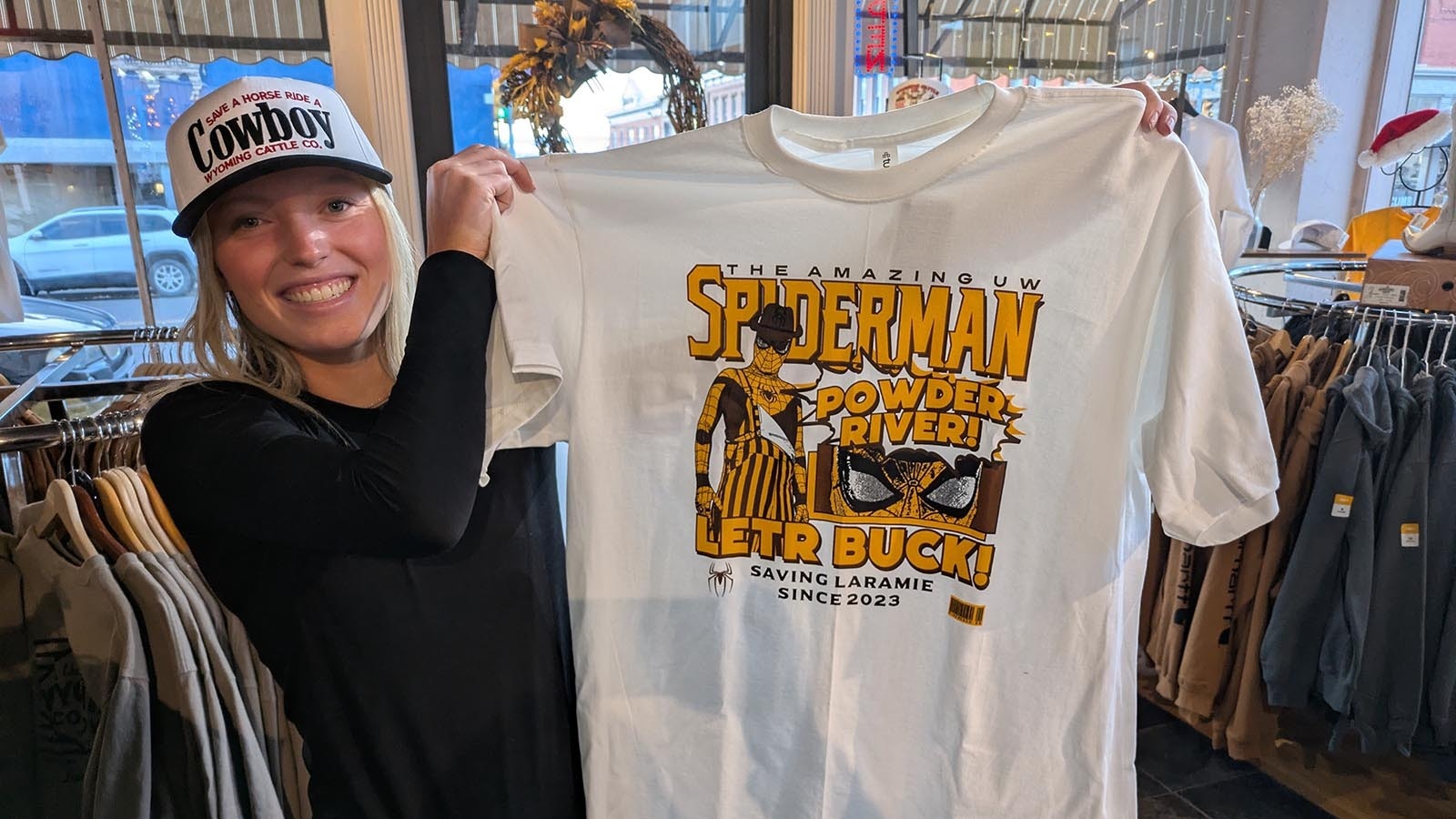 Madi Baillie shows off a special edition T-shirt sold at the Knothole in honor of UW Spiderman.