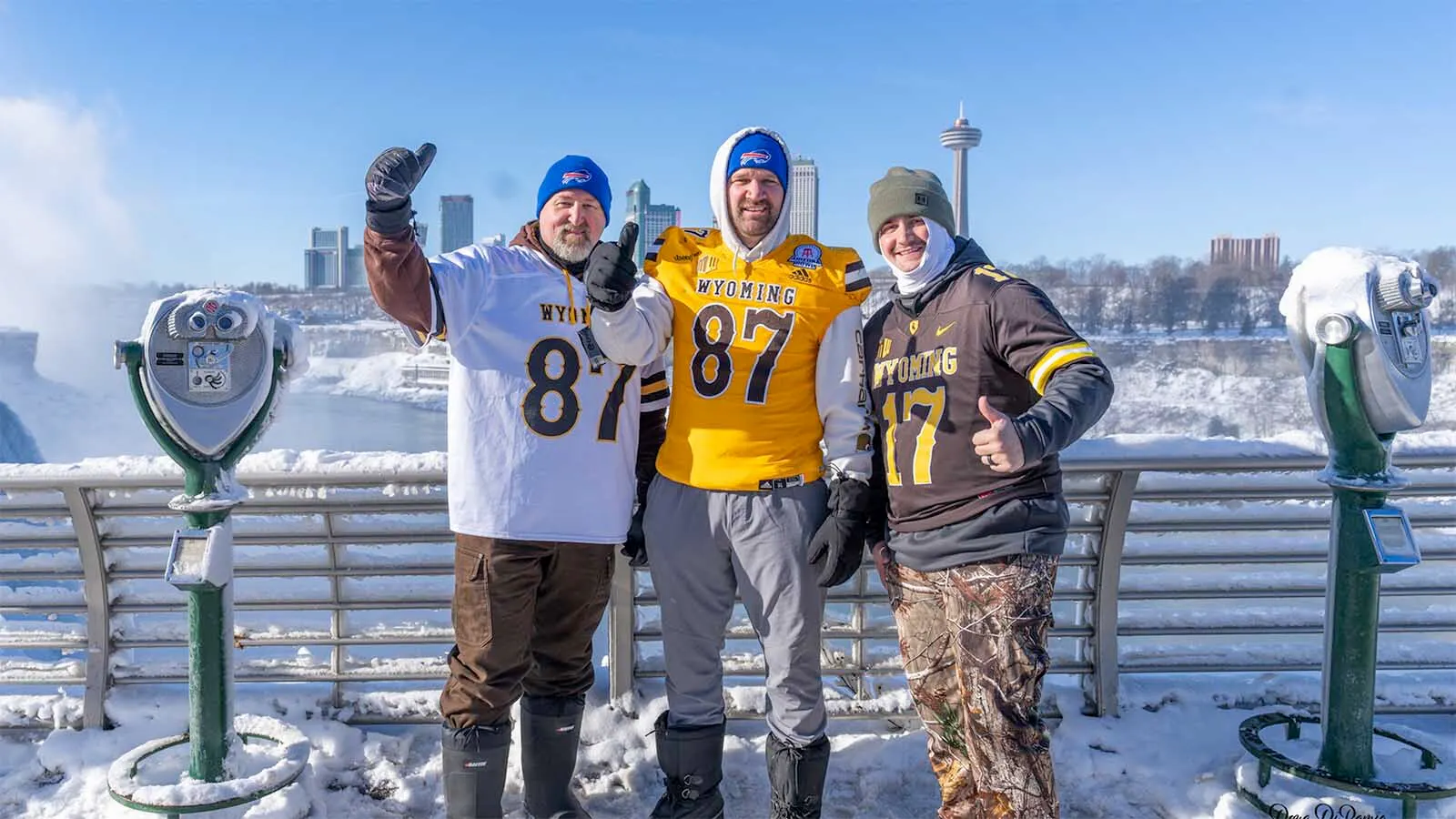 Die-hard University of Wyoming fans wear their UW jerseys and Buffalo Bills beanies while at Niagara Falls, New York, near Buffalo.