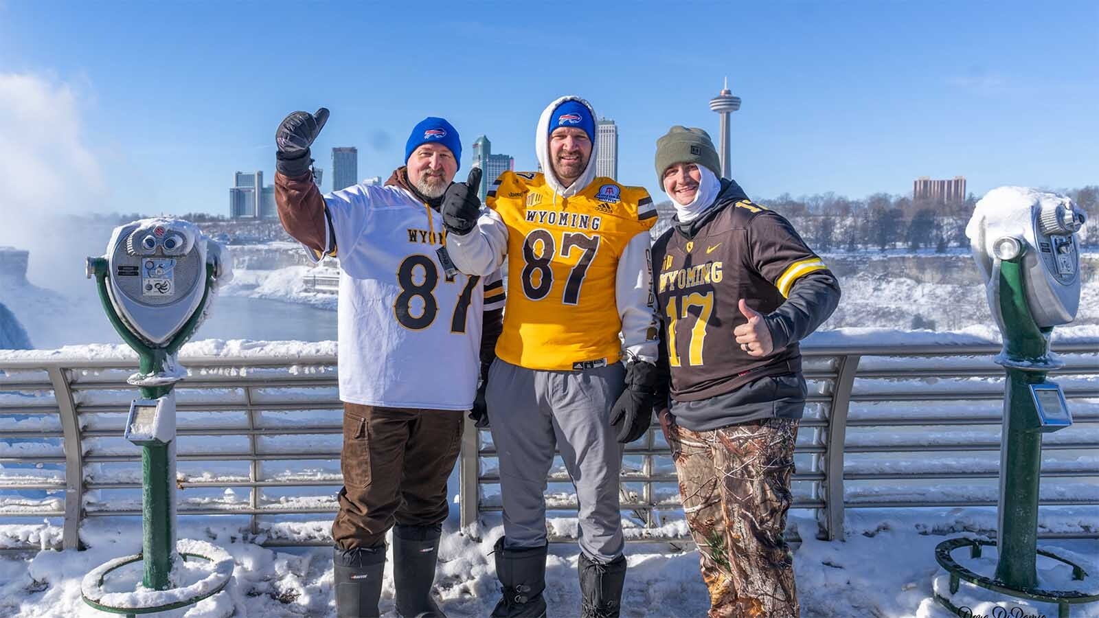 Die-hard University of Wyoming fans wear their UW jerseys and Buffalo Bills beanies while at Niagara Falls, New York, near Buffalo.