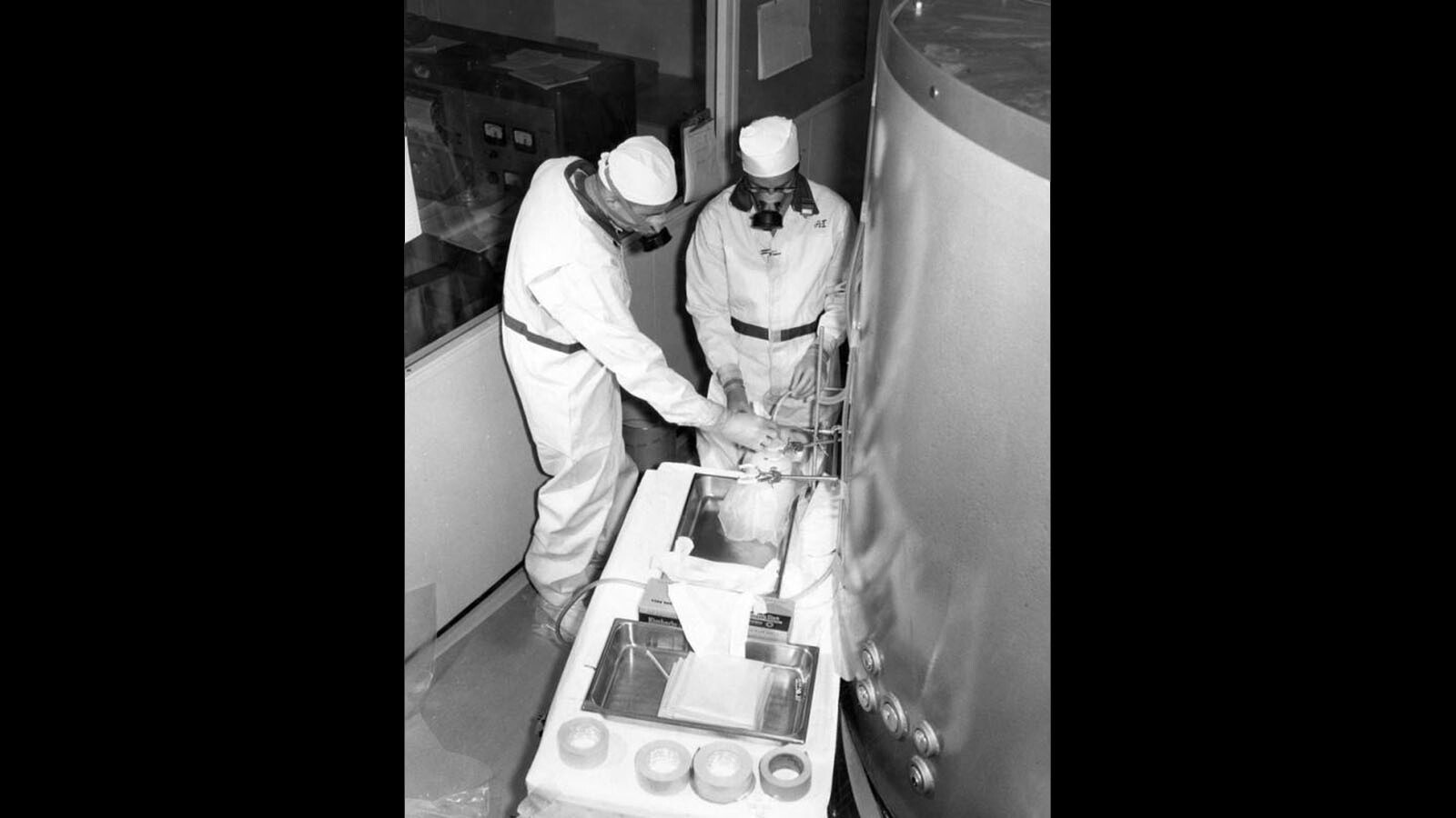 A pair of unidentified students wear respirators as they work next to the containment vessel of the small nuclear reactor that was on the University of Wyoming campus 50 years ago.