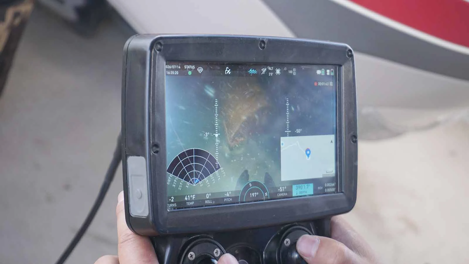 A video screen shows a live feed of an old oil barrel found on the bottom of Fremont Lake.