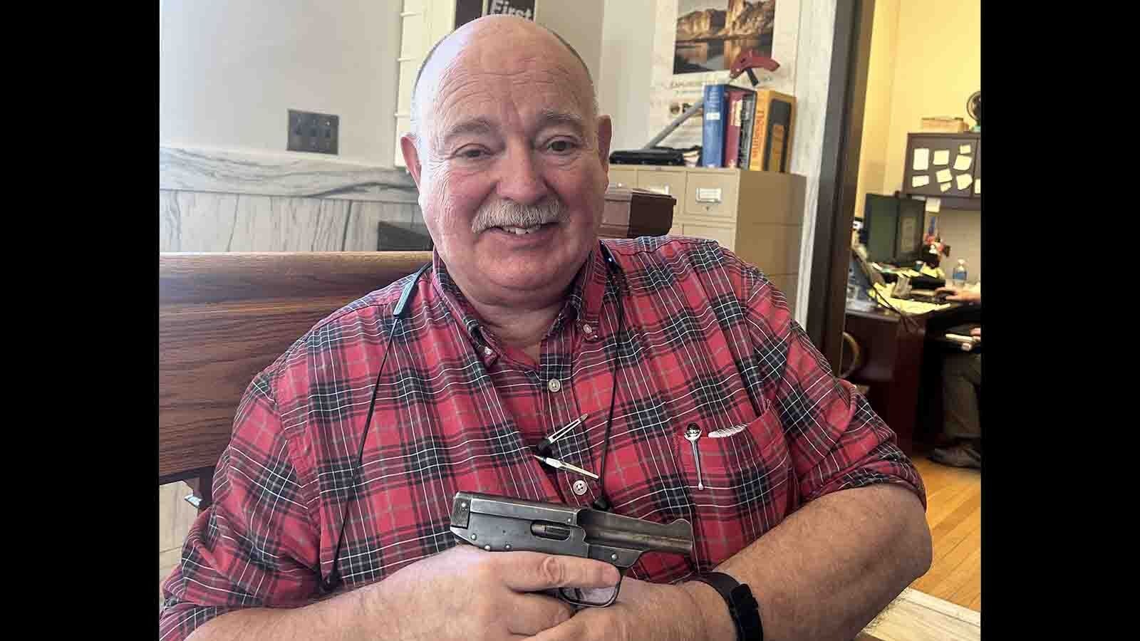Dick Blust researches vintage firearms for the Sweetwater County Historical Museum in Green River. He's seen here with a rare Warner Infallible, which is so ugly it's endearing and so dangerous it shouldn't be fired.