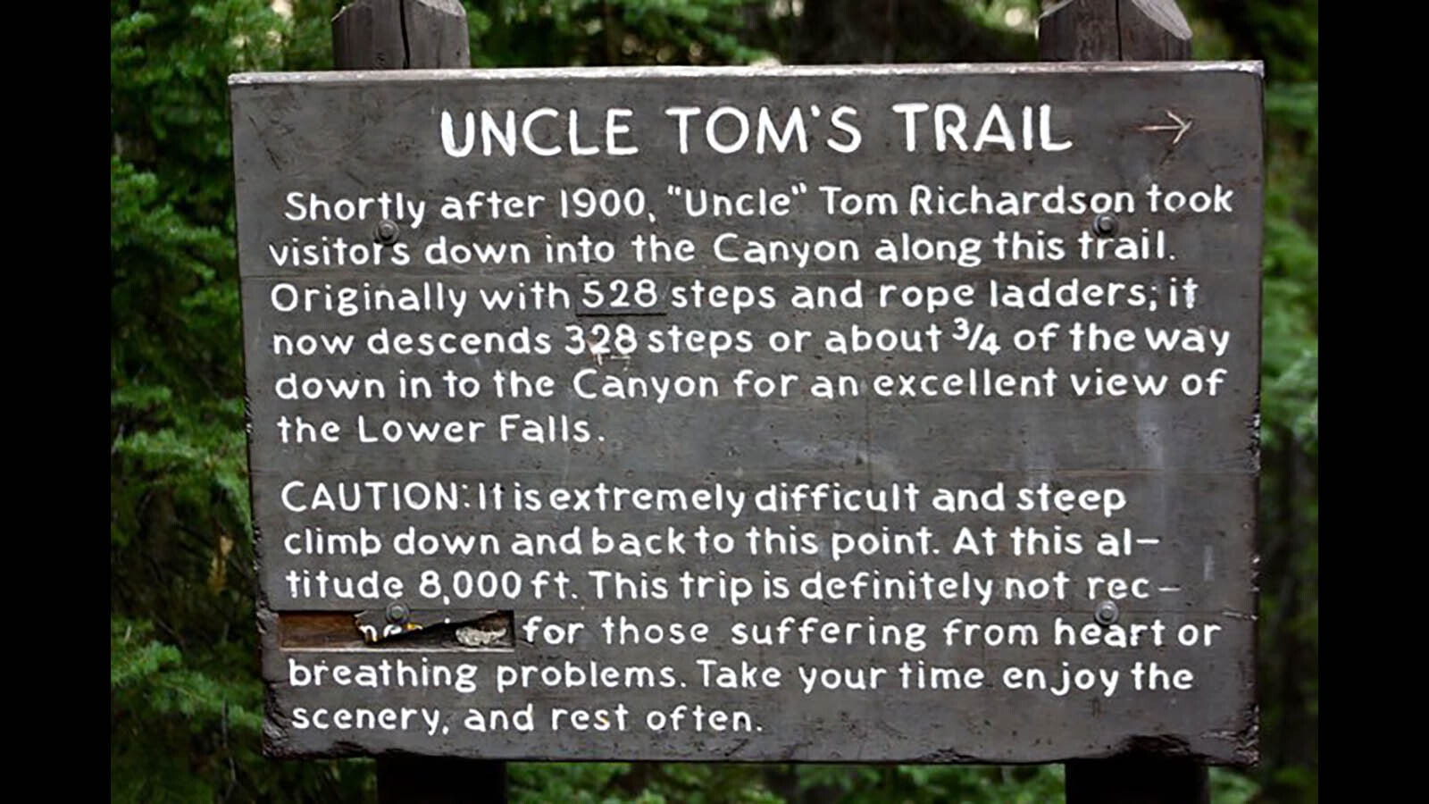 A sign tells Yellowstone visitors the story behind Uncle Tom's Trail.